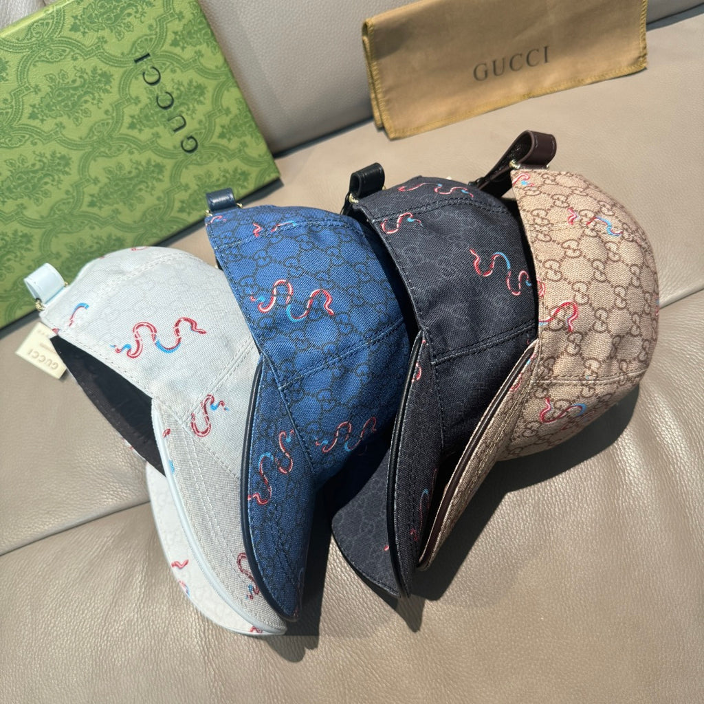 Set of three Gucci caps in white, blue, and beige with snake embroidery