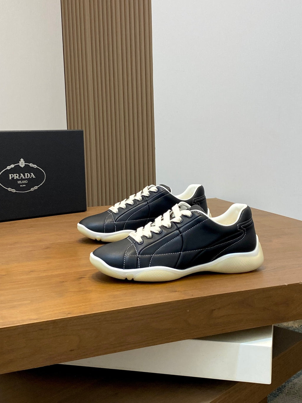 Unisex low-top sneakers, dark navy with white laces and cream rubber sole, side view.