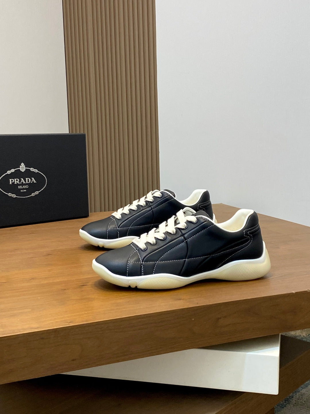 Unisex low-top sneakers, dark navy with white laces and cream rubber sole, side view.