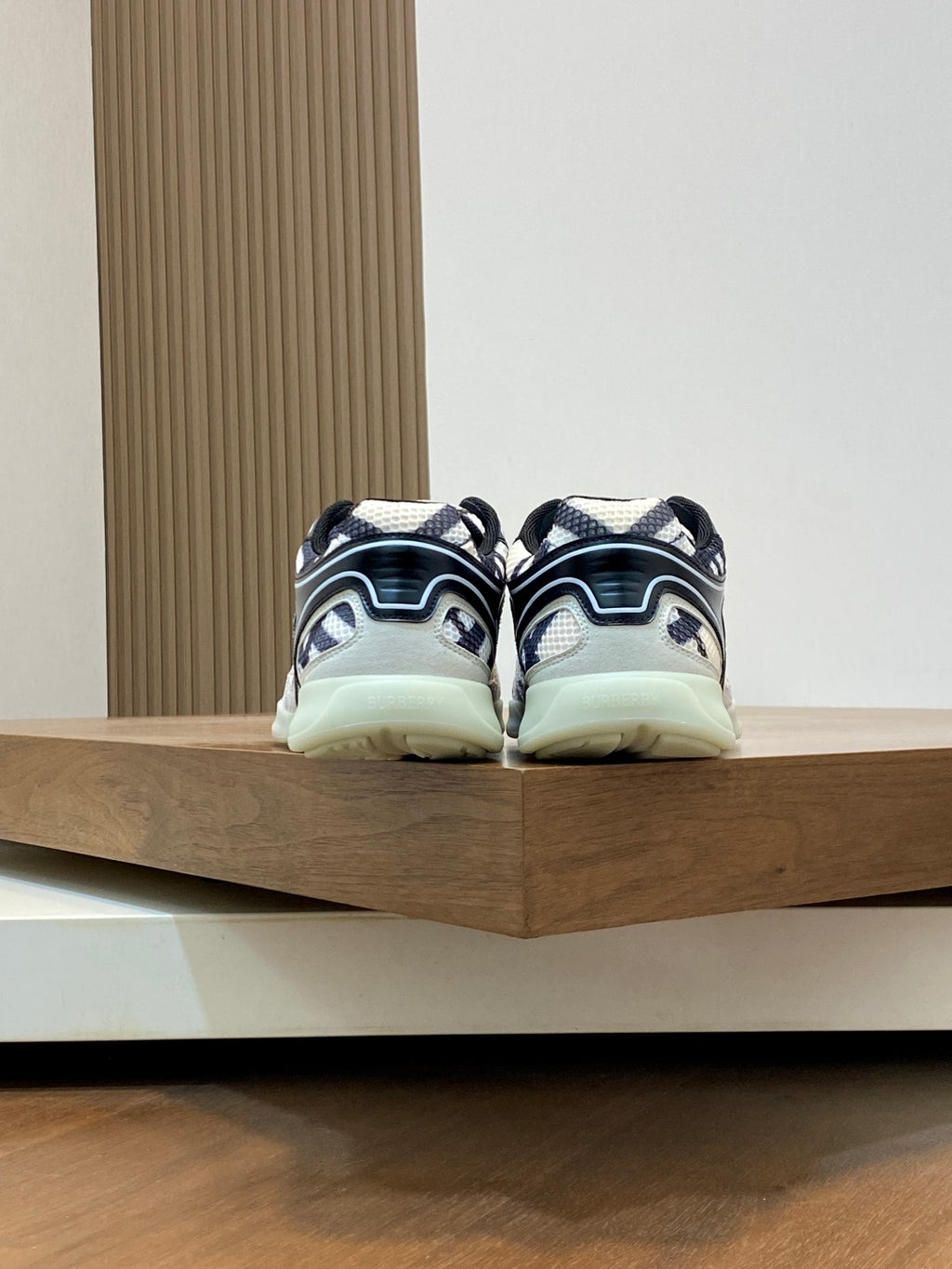 Burberry sneakers from back with navy-and-white patterned uppers and mint outsole
