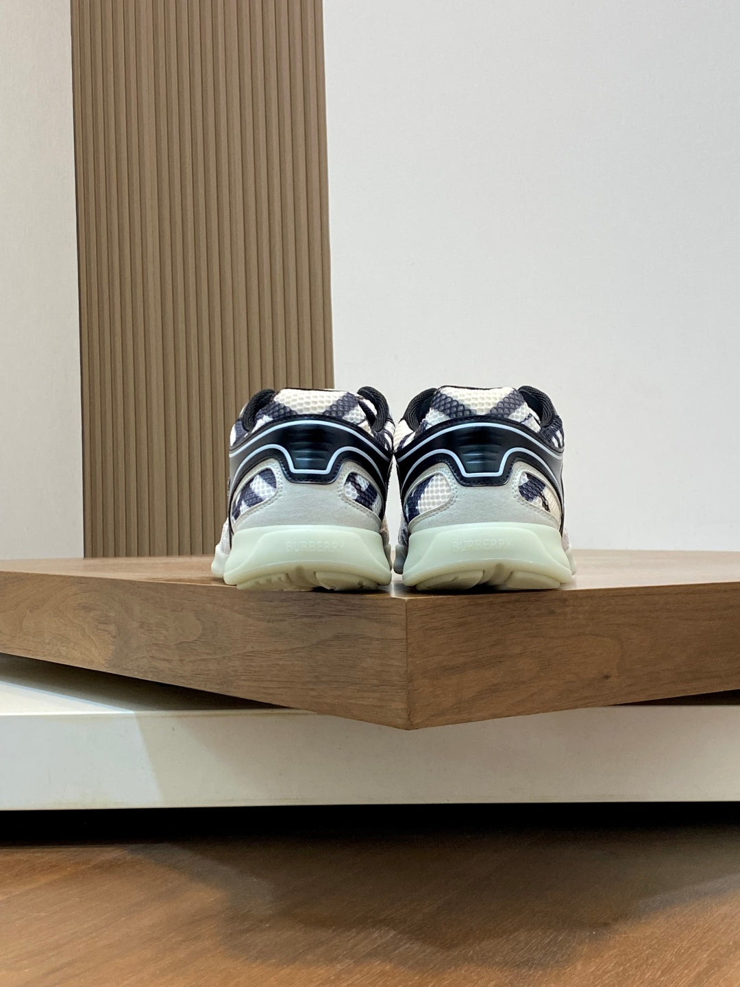 Burberry sneakers from back with navy-and-white patterned uppers and mint outsole