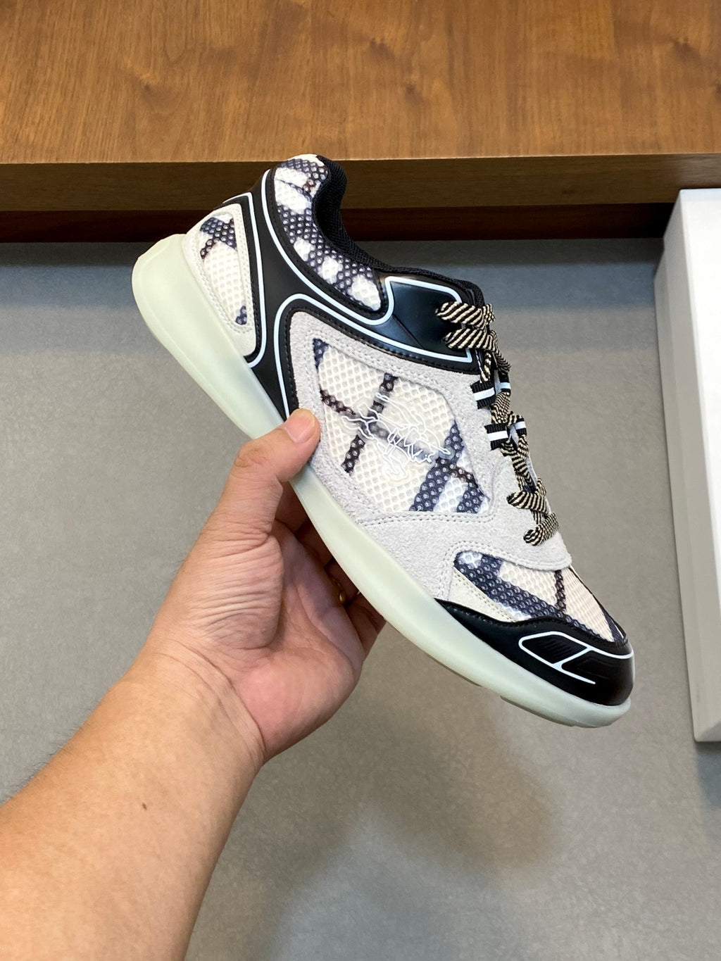 Burberry lace-up sneaker in white with navy accents, detailed stitching, and mint sole