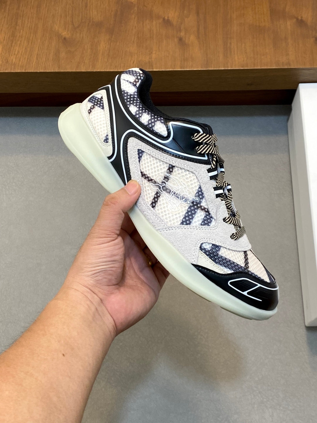 Burberry lace-up sneaker in white with navy accents, detailed stitching, and mint sole