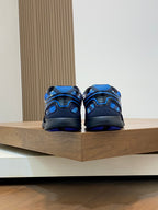 Back view of blue and black athletic sneakers on display shelf