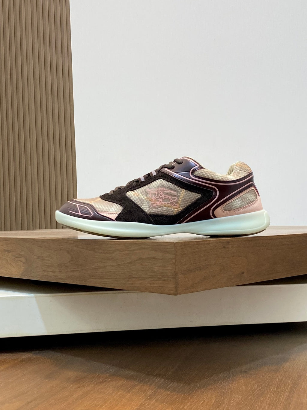 Burberry sneakers side view, maroon trim over beige and black panels, mint outsole