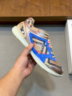 Close-up of blue multicolor lace-up sneaker with patterned upper and cream sole