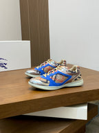 Blue multicolor Burberry sneakers, angled side view on a display platform