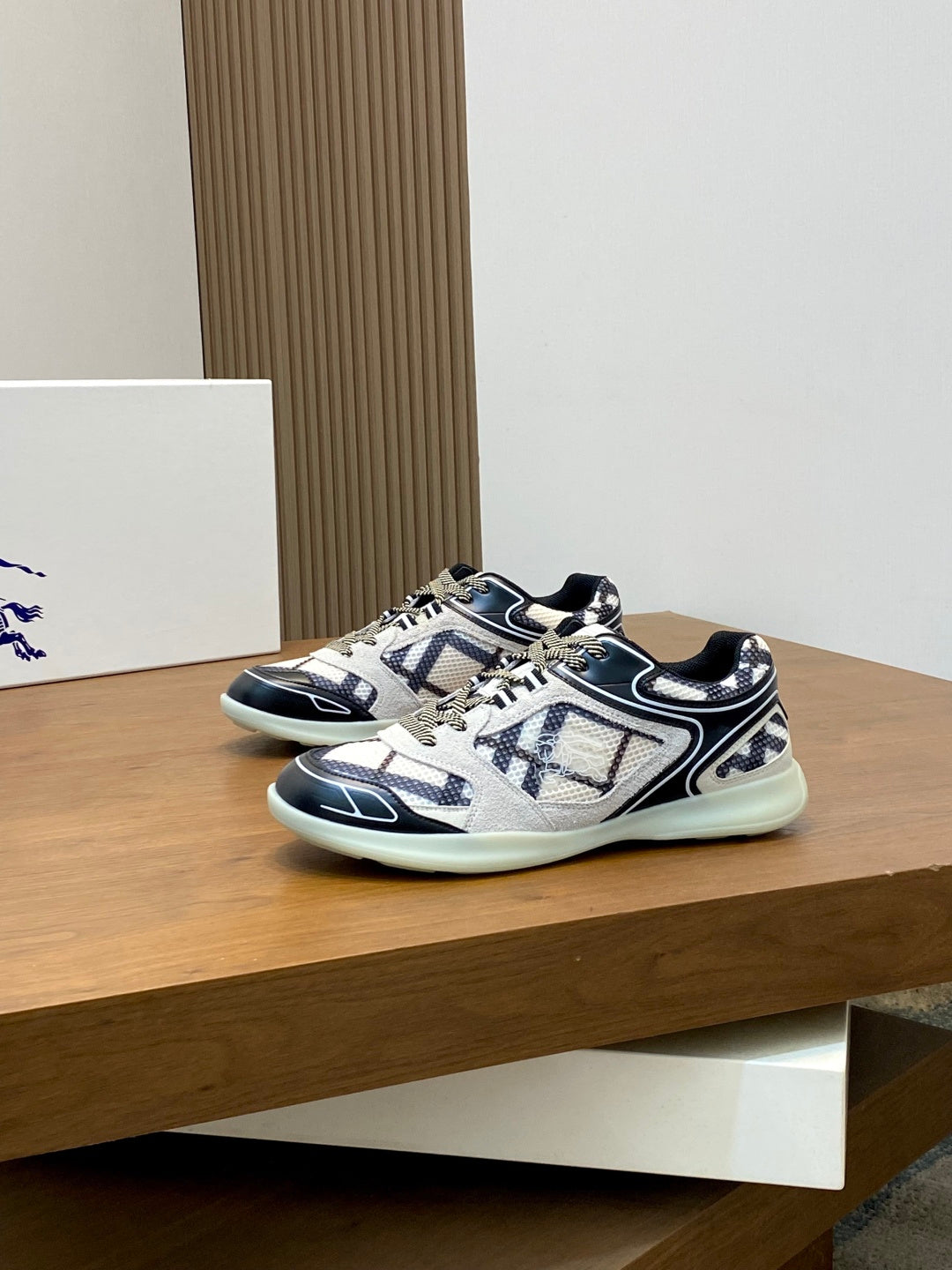 Burberry low-top sneakers with navy-and-white geometric pattern and mint-colored outsole