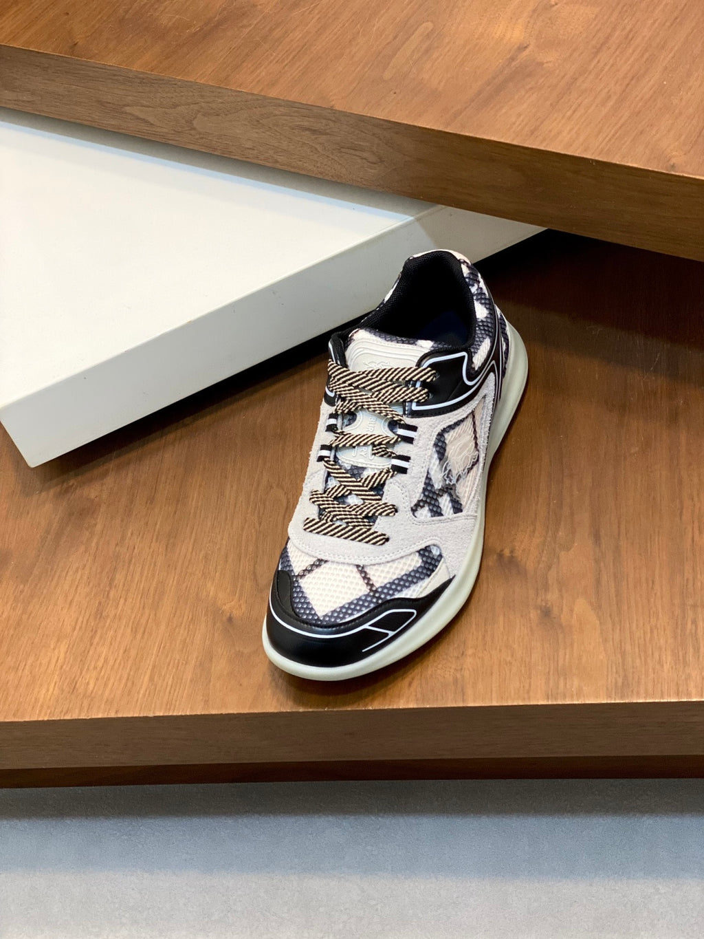 Burberry low-top lace-up sneaker with navy trim, white upper, and mint rubber sole