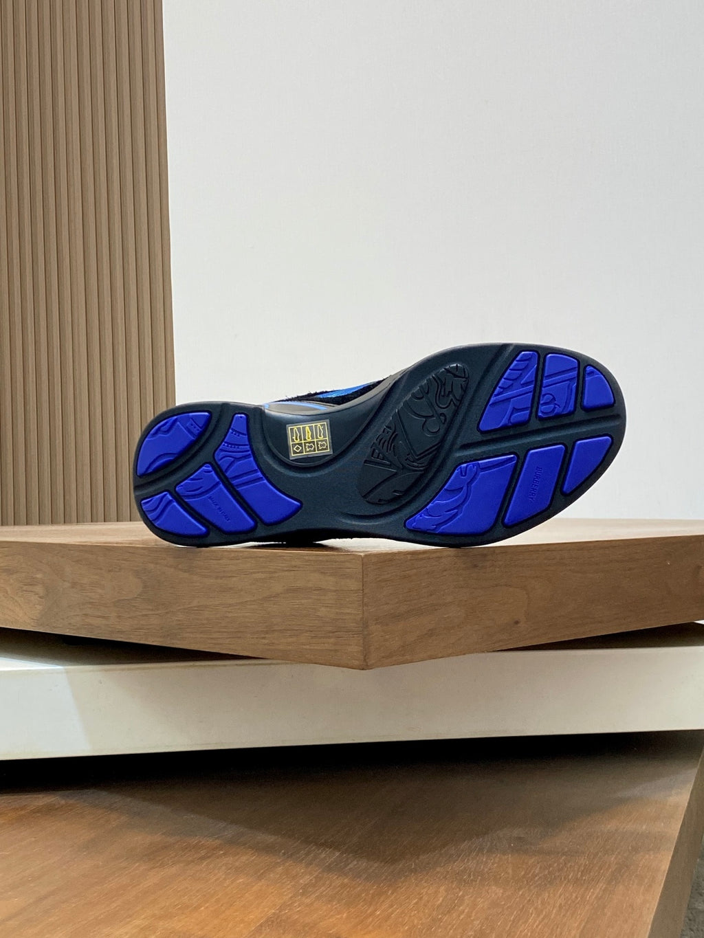 Blue and black sneaker outsole view with tread pattern