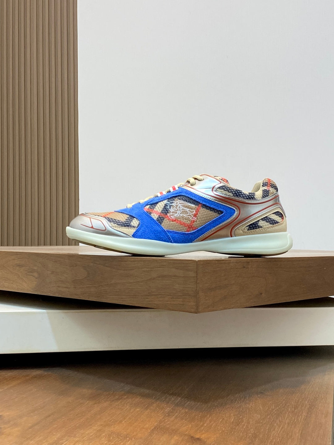 Side view of blue multicolor lace-up sneakers with patterned panels and contrast trim