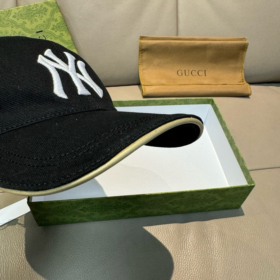 Gucci cap in black with a white NY logo on the side, front brim visible