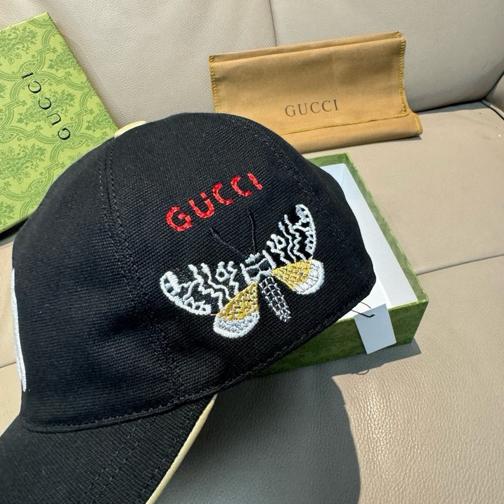 Gucci cap in black with red Gucci text and embroidered butterfly on the front