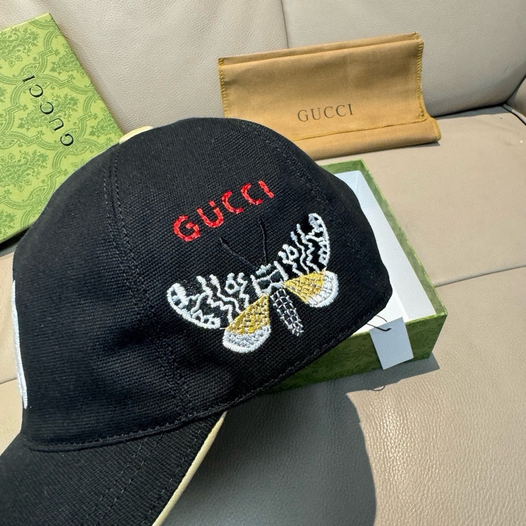 Gucci cap in black with red Gucci text and embroidered butterfly on the front