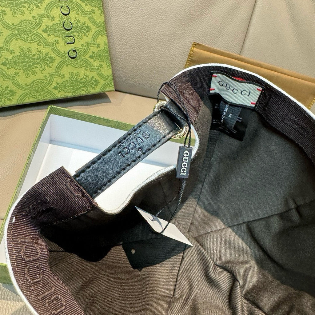 Gucci cap with dark strap and inner label, shown inside bag