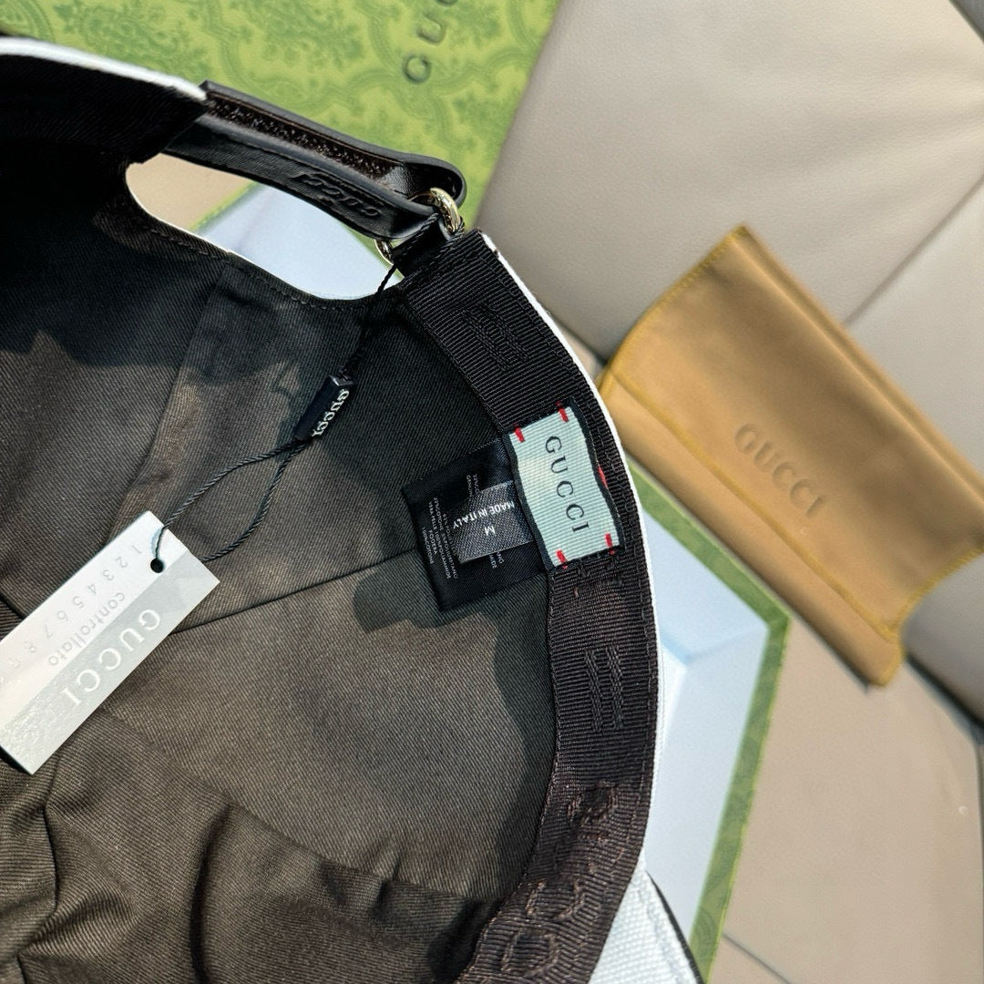 Gucci tote bag and cap items shown together, with black fabric strap and hangtag