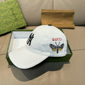 Gucci cap in white canvas with embroidered butterfly logo and red GUCCI text