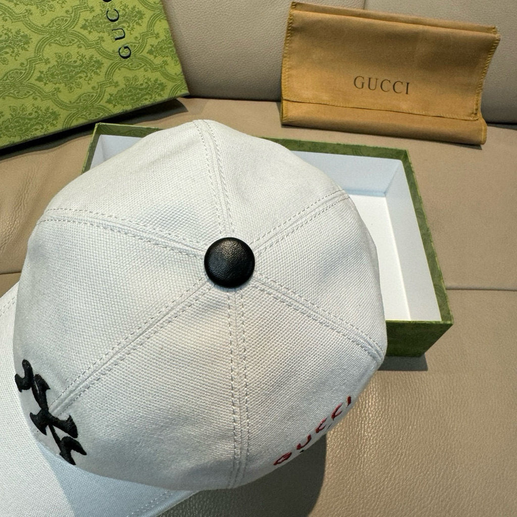 Gucci cap in white canvas with black button top and seam panel stitching