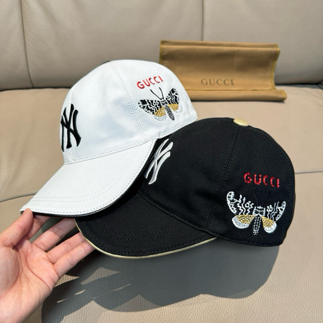 Gucci cap set: white and black caps with embroidered butterfly logos and red GUCCI
