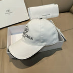 White baseball cap with embroidered BALENCIAGA MODE logo and top button.