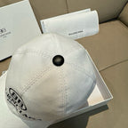 Light baseball cap back view with black top button and small logo patch.