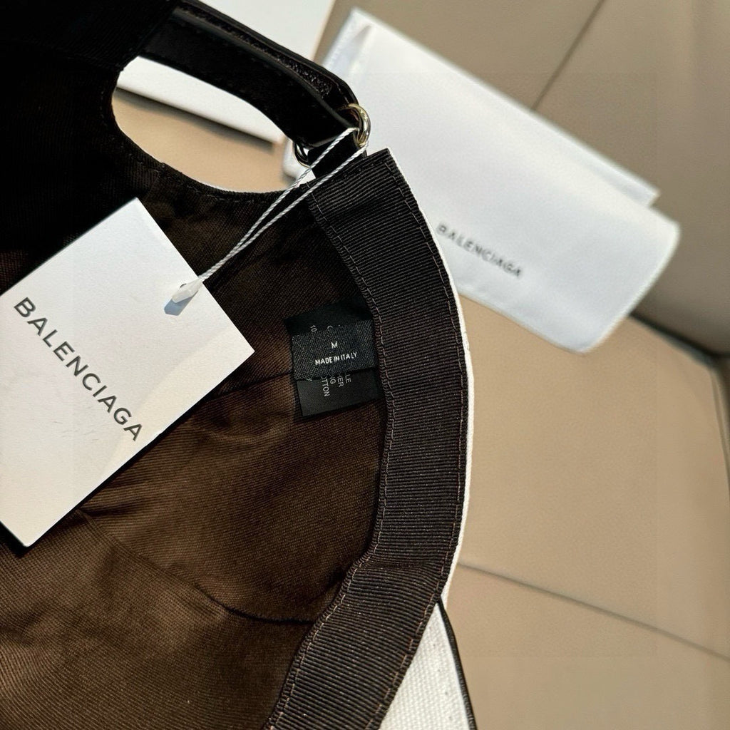 Black baseball cap interior with adjustable strap and brand tag.