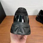 Prada unisex sneaker heel view in black with glossy cap and tread