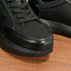 Prada unisex sneaker close-up of laces, textured fabric, and rubber toe cap