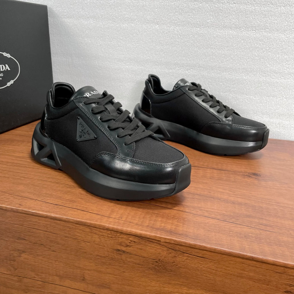Prada unisex sneakers, black, angled side view with chunky rubber sole