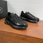 Prada unisex sneakers, black, angled side view with chunky rubber sole