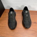 Prada unisex sneakers, black, front view with PRADA logo on tongue