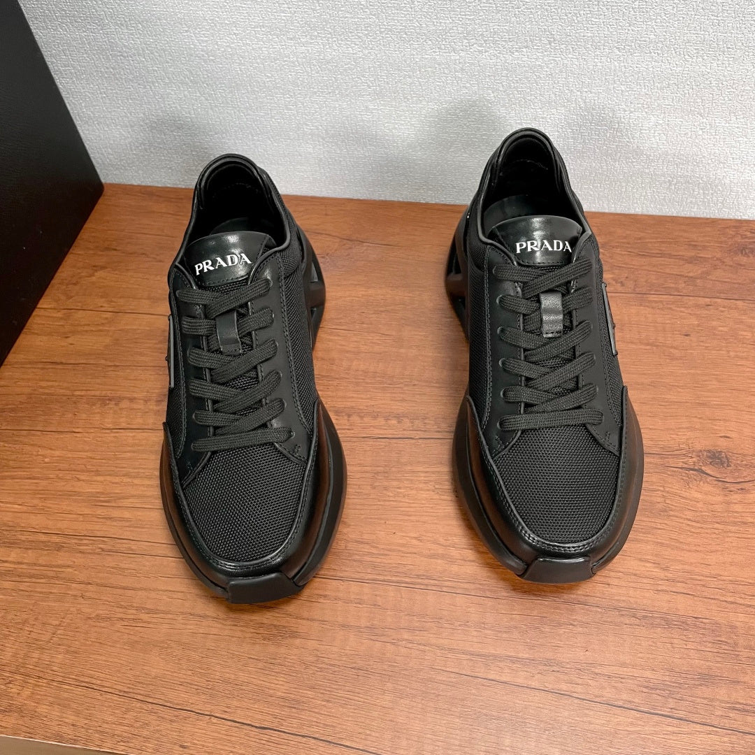 Prada unisex sneakers, black, front view with PRADA logo on tongue