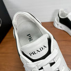 Prada unisex sneaker collar detail, white tongue patch with PRADA lettering and laces.