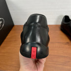 Dark leather sneaker heel with red logo label and textured rubber sole edge