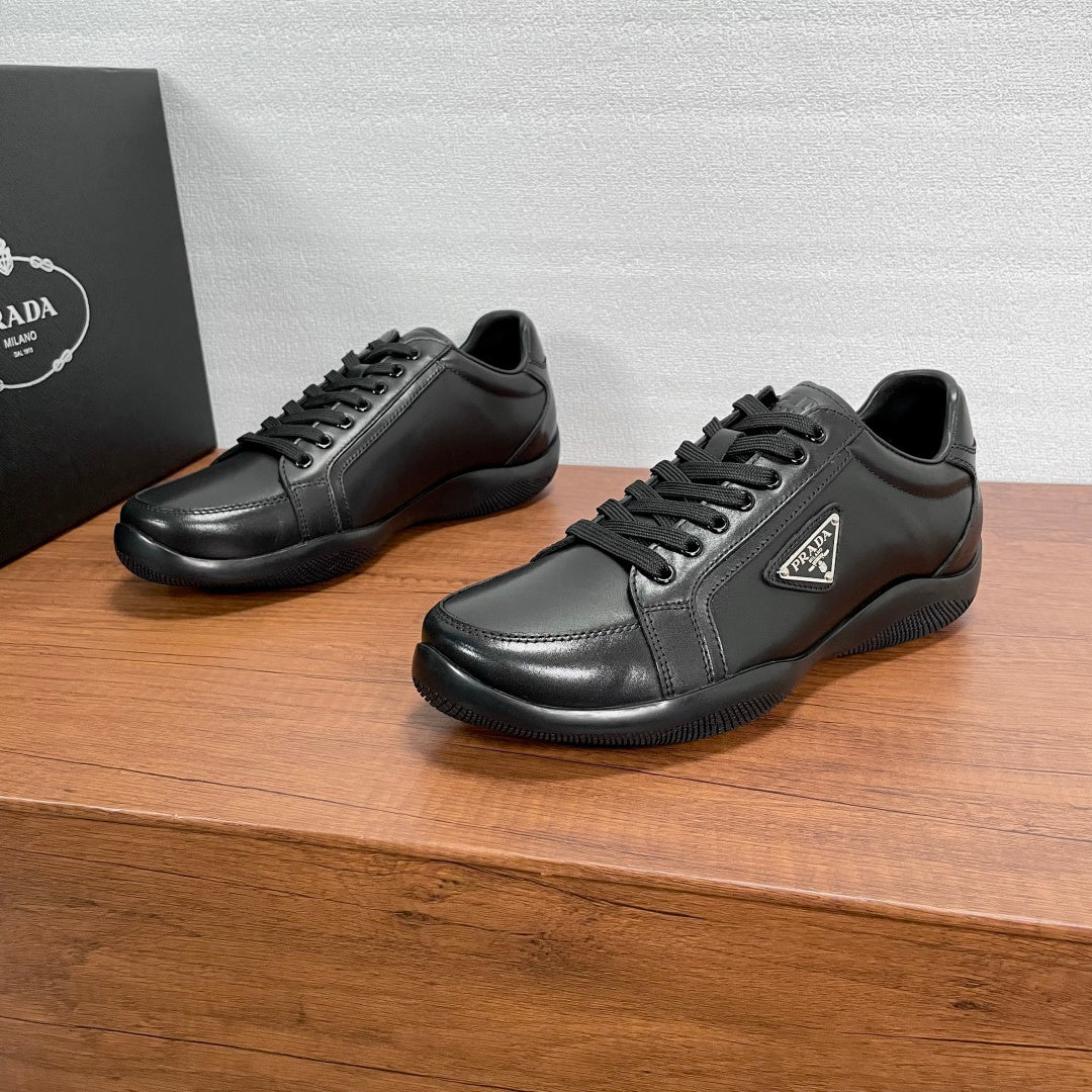 Dark leather unisex sneakers with black laces and low-profile rubber sole