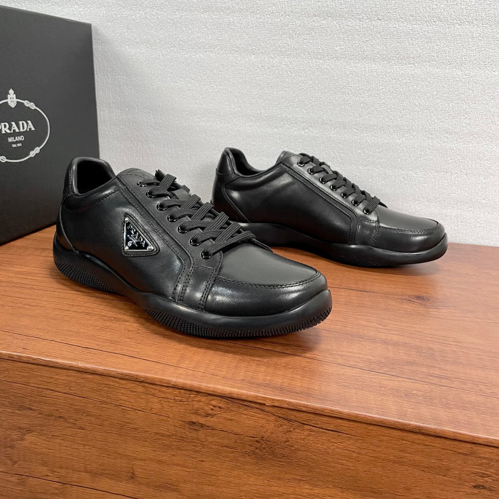 Dark leather unisex sneakers with lace-up fronts and raised tongue logo patch
