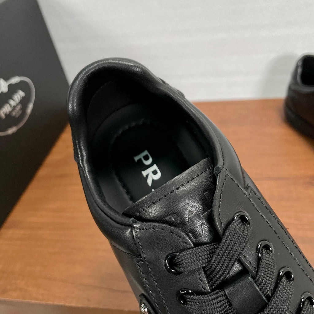 Dark leather sneaker interior with PR logo lettering near collar