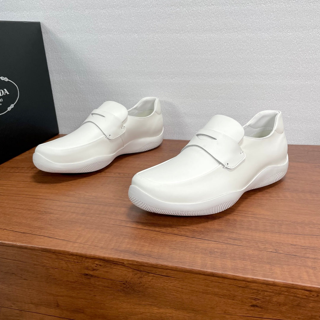 White Prada unisex slip-on loafers with strap and textured rubber sole