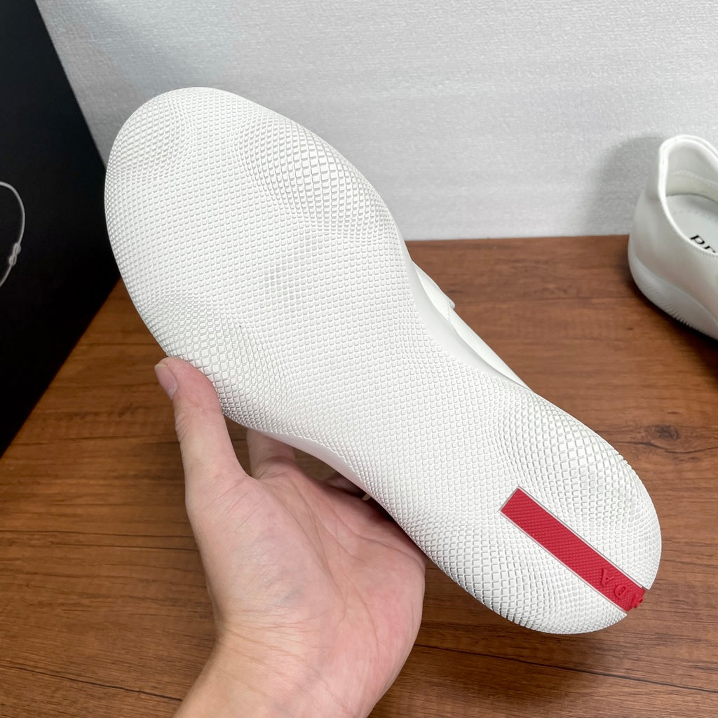 White Prada unisex loafer outsole with red heel accent
