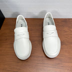White Prada unisex slip-on loafers, front view with stitched strap detail