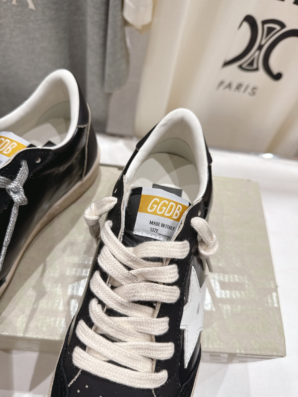 Close-up of black-and-white low-top sneakers with white laces