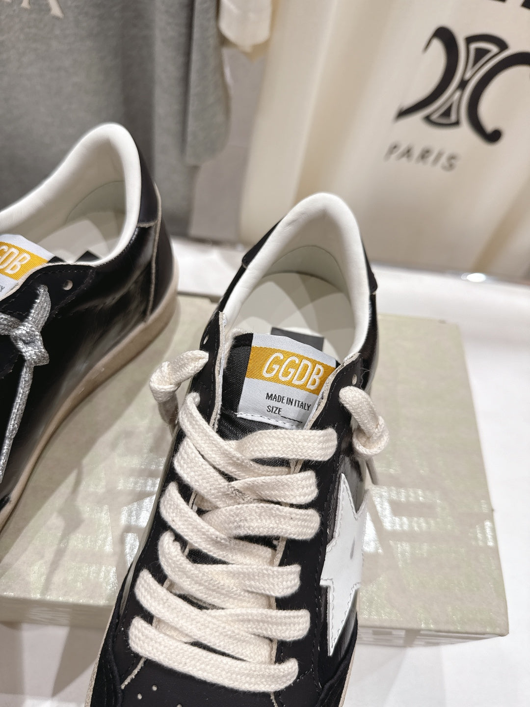 Close-up of black-and-white low-top sneakers with white laces