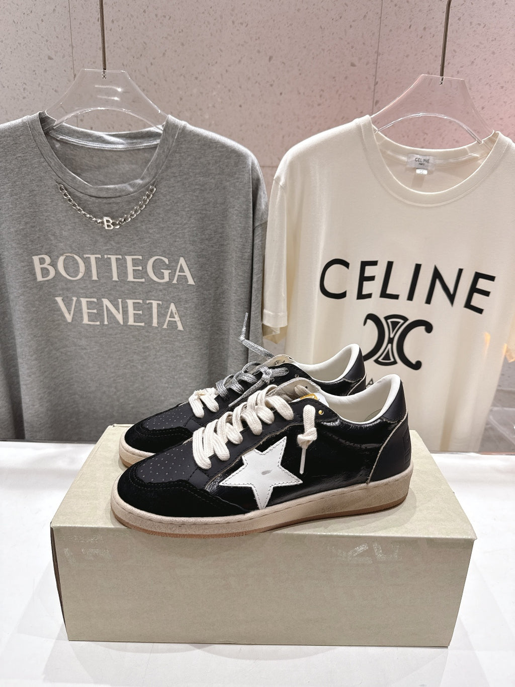 Black low-top sneakers with white star applique and white laces
