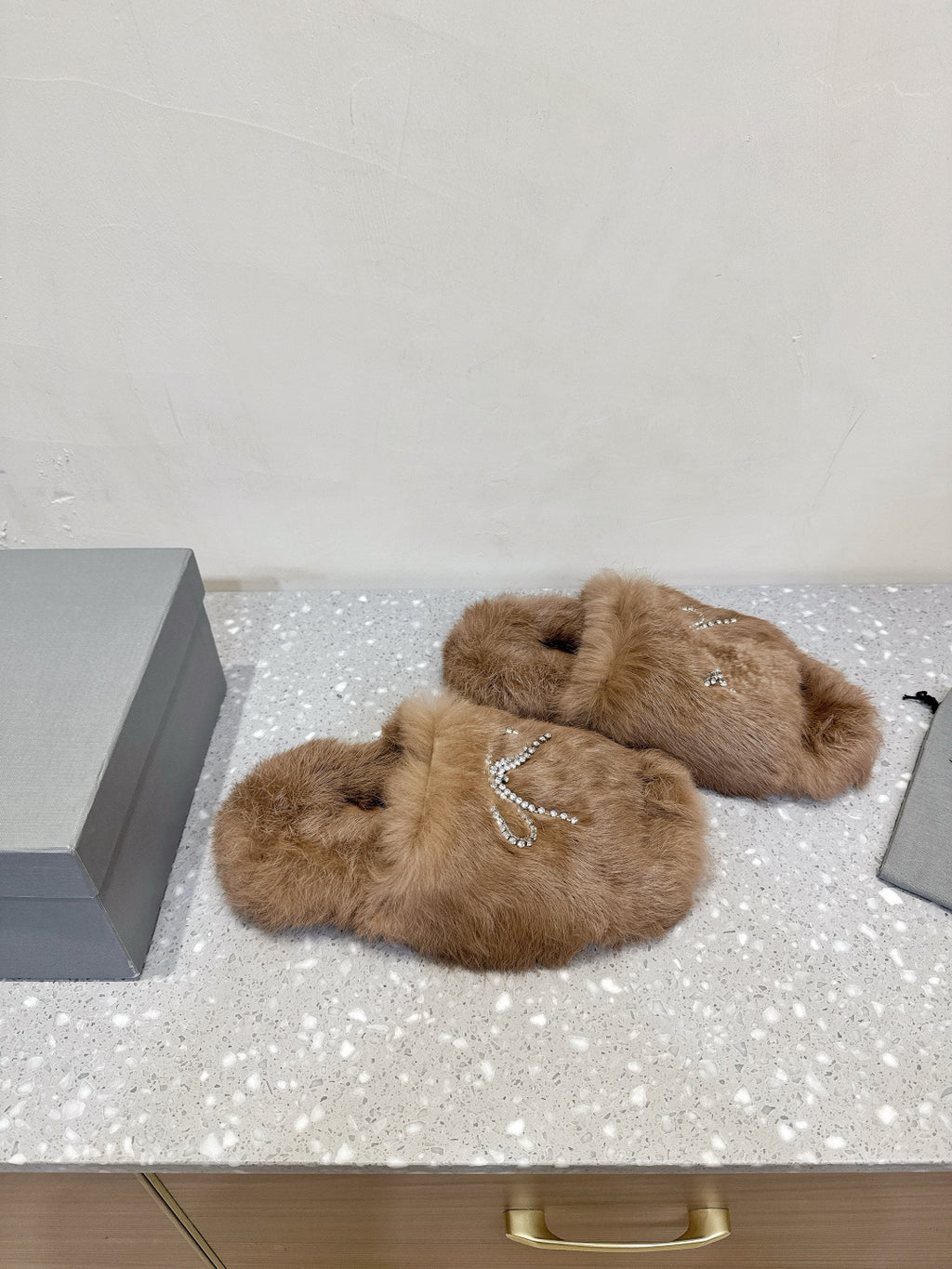Taupe faux-fur slide sandals with rhinestone bow embellishment and open toe