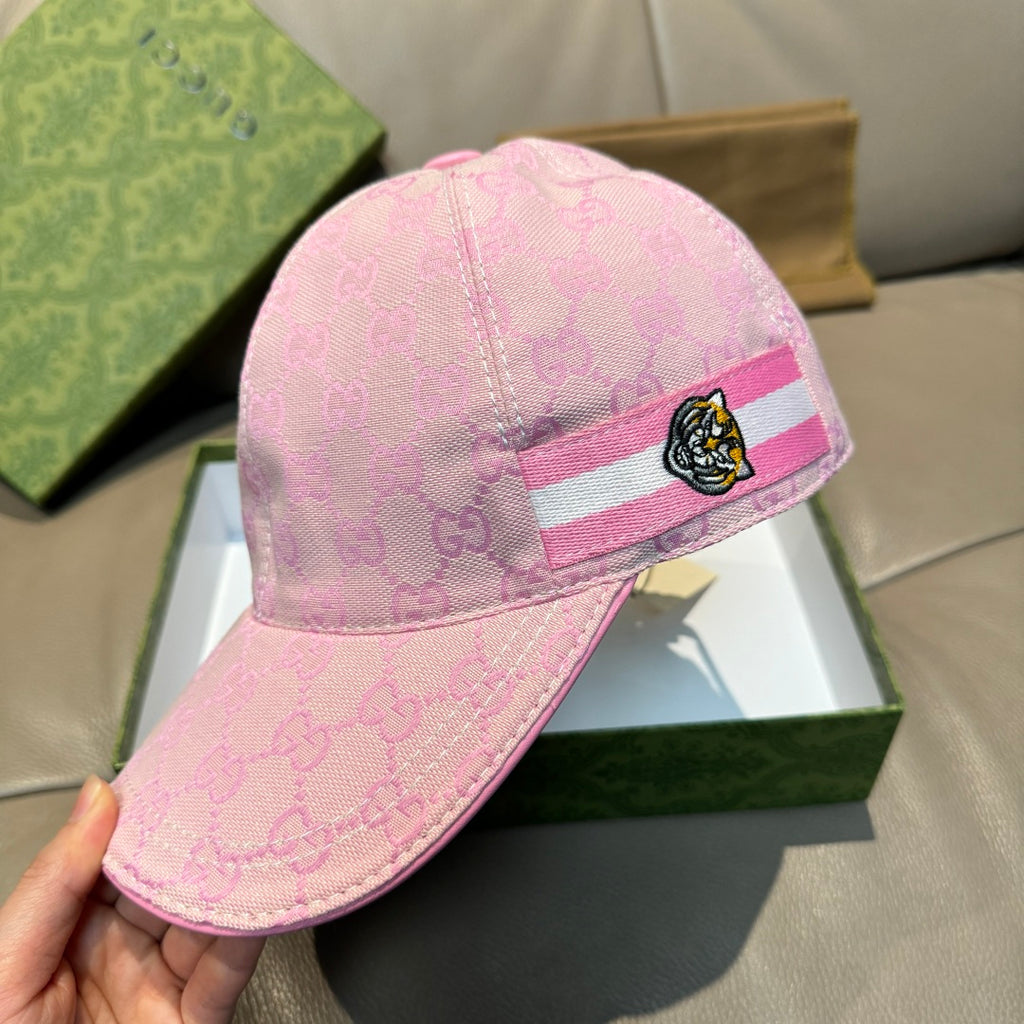 Pink GG-logo baseball cap on box, striped band with tiger head patch