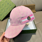 Pink GG-logo baseball cap on box, striped band with tiger head patch