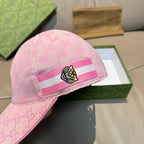 Pink GG-logo baseball cap close-up, tiger head patch on striped band