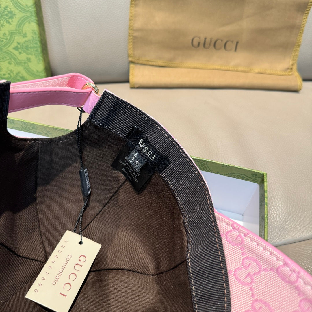 Pink baseball cap with Gucci tags and black strap detail