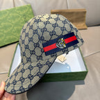 Blue Gucci GG cap with red and blue striped band and central bee emblem