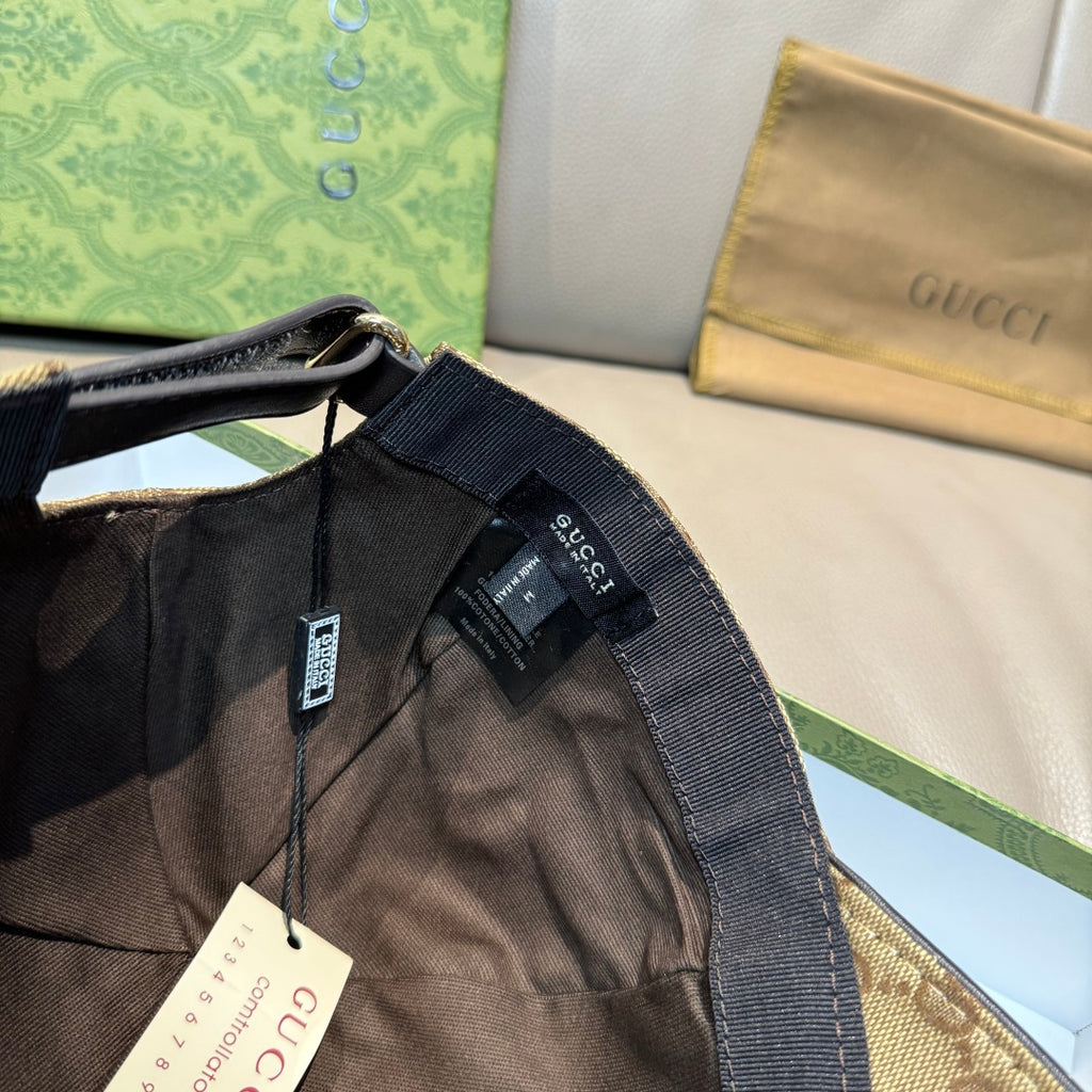 Gucci cap side with dark webbing strap and hanging labels